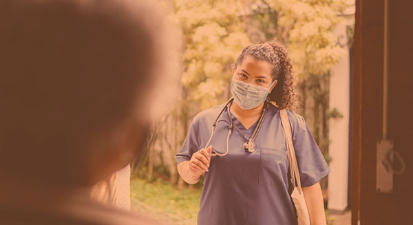 Home health nurse at a patients front door