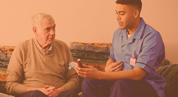Home care clinician sitting on couch educating a patient or family member