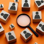 blocks with male image next to a magnifying glass