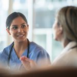 Two medical professionals talking to each other